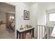 Bright hallway with decorative table and a glimpse into a well-lit bedroom featuring neutral tones at 705 11Th Ave. S, North Myrtle Beach, SC 29582