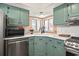 Bright kitchen featuring teal cabinets, stainless steel appliances and a bay window at 705 11Th Ave. S, North Myrtle Beach, SC 29582