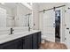 Bathroom with double vanity, modern fixtures, and walk-in closet behind sliding barn door at 759 Painted Bunting Ct. # A, Murrells Inlet, SC 29576