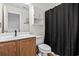 Bathroom featuring a wooden vanity, toilet and shower with dark shower curtain at 759 Painted Bunting Ct. # A, Murrells Inlet, SC 29576