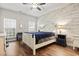 Bright bedroom featuring a wood accent wall, ceiling fan, and wood-look flooring at 759 Painted Bunting Ct. # A, Murrells Inlet, SC 29576