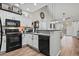 Modern kitchen featuring white cabinets, black appliances, and an open layout, perfect for cooking and entertaining at 759 Painted Bunting Ct. # A, Murrells Inlet, SC 29576