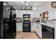 Modern kitchen featuring white cabinets, black appliances, and an open layout, perfect for cooking and entertaining at 759 Painted Bunting Ct. # A, Murrells Inlet, SC 29576