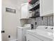 Well-organized laundry area featuring washer, dryer, and stylish storage at 759 Painted Bunting Ct. # A, Murrells Inlet, SC 29576