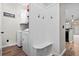 Inviting mud room with coat hooks and bench seating, plus a modern washer and dryer setup at 759 Painted Bunting Ct. # A, Murrells Inlet, SC 29576