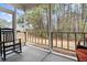 Screened in porch with a rocking chair and view of the backyard at 759 Painted Bunting Ct. # A, Murrells Inlet, SC 29576