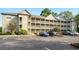 Attractive condo building with multiple levels and balconies, surrounded by well-maintained landscaping at 922 Fairwood Lakes Ln. # 22M, Myrtle Beach, SC 29588