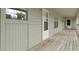 Exterior hallway with white door and neutral siding provides access to units at 922 Fairwood Lakes Ln. # 22M, Myrtle Beach, SC 29588