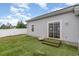 Backyard showcasing sliding glass door, artificial turf, and privacy fence at 9545 Sullivan Dr., Murrells Inlet, SC 29576