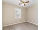 This bedroom features neutral walls, wood floors, and a window to let in natural light at 9545 Sullivan Dr., Murrells Inlet, SC 29576