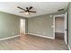 Bedroom showcasing ceiling fan, a walk-in closet, and neutral paint at 9545 Sullivan Dr., Murrells Inlet, SC 29576