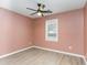 Cozy bedroom featuring neutral walls, modern flooring, a ceiling fan, and a bright window at 9545 Sullivan Dr., Murrells Inlet, SC 29576