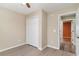 This bedroom includes gray wood floors, a closet, neutral walls, and white trim at 9545 Sullivan Dr., Murrells Inlet, SC 29576