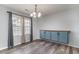 Bright dining room features stylish chandelier, storage cabinet, and natural light at 9545 Sullivan Dr., Murrells Inlet, SC 29576