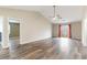 Open-concept living room with gray-toned wood floors, a window, and high ceilings at 9545 Sullivan Dr., Murrells Inlet, SC 29576