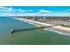 Overhead view of a pier, beach and multiple high-rise condo buildings along the coastline at 9620 Shore Dr. # C101, Myrtle Beach, SC 29572