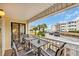 Balcony with tables and chairs overlooking the parking area and neighboring buildings at 9620 Shore Dr. # C101, Myrtle Beach, SC 29572