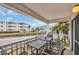 Balcony with tables and chairs overlooking the parking area and neighboring buildings at 9620 Shore Dr. # C101, Myrtle Beach, SC 29572