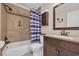 Full bathroom with a shower-tub combo featuring decorative tile accents and a stylish vanity area at 9620 Shore Dr. # C101, Myrtle Beach, SC 29572