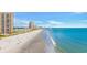 Scenic view of the beach with multiple high-rise condos in the distance on a sunny day at 9620 Shore Dr. # C101, Myrtle Beach, SC 29572