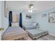 Light blue bedroom with a trundle bed, and window with dark blue curtain at 9620 Shore Dr. # C101, Myrtle Beach, SC 29572