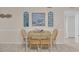 Cozy dining area with a wooden table, seating for four, and beach-themed decorations at 9620 Shore Dr. # C101, Myrtle Beach, SC 29572