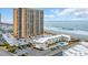 View of a high-rise condominium with the beach in the background on a sunny day at 9620 Shore Dr. # C101, Myrtle Beach, SC 29572