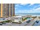 Exterior view of the condo and parking lot near the ocean with clear blue skies at 9620 Shore Dr. # C101, Myrtle Beach, SC 29572