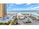 Exterior view of a beach condo and parking lot near the ocean with palm trees on a sunny day at 9620 Shore Dr. # C101, Myrtle Beach, SC 29572