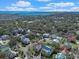 An aerial view of the community showcases homes surrounded by trees, and ocean views on the horizon at 10 Orchard Ave., Murrells Inlet, SC 29576