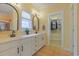 Bathroom featuring a double vanity with modern mirrors and a walk-in closet at 10 Orchard Ave., Murrells Inlet, SC 29576