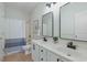 Bright bathroom featuring double sinks, modern fixtures, and a shower-tub combo at 10 Orchard Ave., Murrells Inlet, SC 29576