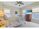 Cozy bedroom featuring neutral walls, two windows, and a television on a chest of drawers at 10 Orchard Ave., Murrells Inlet, SC 29576