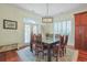 Elegant dining room featuring a glass-top table, seating for eight, and natural light at 10 Orchard Ave., Murrells Inlet, SC 29576