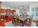 Inviting dining room connects to the kitchen, featuring a modern chandelier and ample seating at 10 Orchard Ave., Murrells Inlet, SC 29576