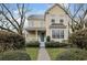 Charming yellow two-story home with a welcoming front porch and beautiful landscaping at 10 Orchard Ave., Murrells Inlet, SC 29576