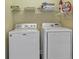 Functional laundry room featuring a washer, dryer, and storage shelf at 10 Orchard Ave., Murrells Inlet, SC 29576