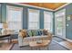 Comfortable living room features a wooden ceiling, plentiful pillows, and natural light at 10 Orchard Ave., Murrells Inlet, SC 29576