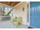 Inviting porch with wooden ceiling fan and green Adirondack chairs at 10 Orchard Ave., Murrells Inlet, SC 29576