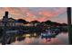 Waterfront dining spot features outdoor seating, boat docks, and colorful skies at sunset at 10 Orchard Ave., Murrells Inlet, SC 29576