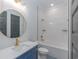 Modern bathroom features a blue vanity, gold fixtures, and a tub with white subway tile surround at 1054 East Isle Of Palms Ave., Myrtle Beach, SC 29579