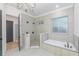 Spacious bathroom featuring a walk-in shower, soaking tub, tiled walls and a window for natural light at 1054 East Isle Of Palms Ave., Myrtle Beach, SC 29579