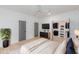 Brightly lit bedroom with large closet, flat screen tv, ceiling fan, and hardwood flooring at 1054 East Isle Of Palms Ave., Myrtle Beach, SC 29579