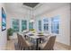 Elegant dining room with large windows, a modern chandelier, and stylish decor creating an inviting atmosphere at 1054 East Isle Of Palms Ave., Myrtle Beach, SC 29579