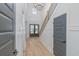 Bright foyer showcases wood floors, paneled walls, a modern chandelier, and a staircase with black metal railings at 1054 East Isle Of Palms Ave., Myrtle Beach, SC 29579