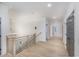 Upstairs hallway features wood floors, wainscoting, black hardware, and decorative lighting at 1054 East Isle Of Palms Ave., Myrtle Beach, SC 29579