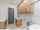 Bright laundry room with modern wood cabinets, white countertops and a stylish dark gray door at 1054 East Isle Of Palms Ave., Myrtle Beach, SC 29579