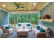 Screened-in porch features cozy wicker seating with turquoise cushions and wood ceiling at 1054 East Isle Of Palms Ave., Myrtle Beach, SC 29579