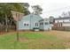 Back view of home with a large backyard, wooden privacy fence and lots of green grass at 1105 Palmetto St., Georgetown, SC 29440