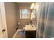 Gray-painted bathroom with standard white toilet, sink, and shower at 1105 Palmetto St., Georgetown, SC 29440